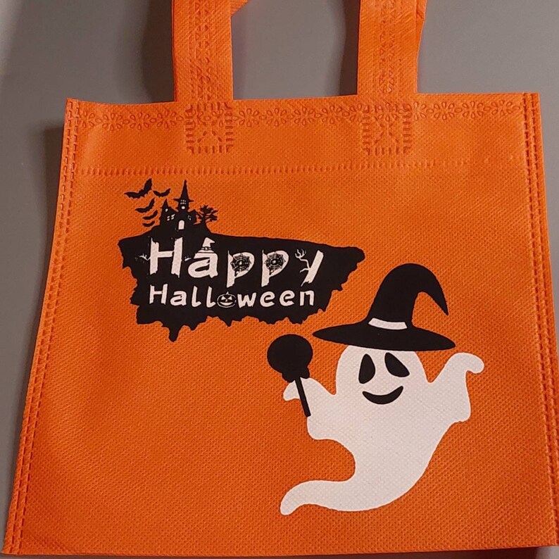 May include: Orange reusable tote bag with a white ghost holding a lollipop and the text "Happy Halloween".