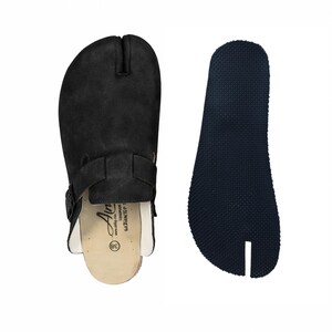 May include: Black split-toe clog sandal with a buckle strap and a separate dark blue sole. The sandal has a cork footbed and the text "Air" is visible. The size is marked as 38.