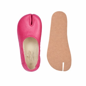 May include: Bright pink split-toe ballet flats with a separate tan insole. The flats have a rounded toe and a split design for the big toe. The insole is textured. The flats are designed for dance or casual wear.