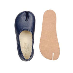 May include: A set of three ceramic mugs with a speckled, matte finish. The mugs are in shades of cream, light gray, and dark gray. Each mug has a simple, minimalist design and a rounded handle.