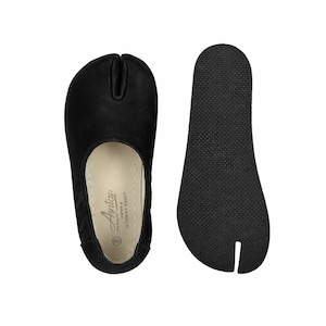 May include: Black split-toe shoes, also known as Tabi shoes, with a rubber sole. The shoes have a unique design that separates the big toe from the other toes. The shoes are size 38.