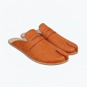 May include: A pair of orange-brown split-toe slip-on shoes. The shoes have a strap across the top and a light-colored sole. The design features a separate section for the big toe.