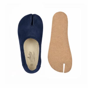 May include: Navy blue split-toe shoe with a matching insole. The shoe has a rounded toe and a split between the big toe and the other toes. The insole is tan with a textured surface. The shoe has the brand name "Antap" printed on the insole.