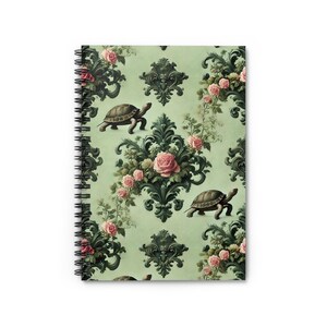 May include: A green and white patterned notebook cover with a repeating design of tortoises and pink roses. The design is reminiscent of vintage wallpaper.