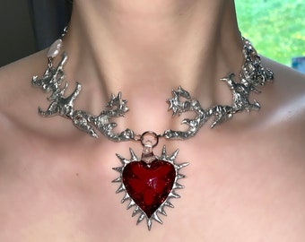 Handmade metal abstract necklace with spiky red glass heart pendant