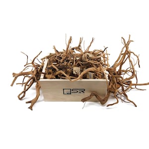 May include: A wooden box filled with a large quantity of brown driftwood branches. The box is labeled "SR Aquaristik" and is a great addition to any aquarium.