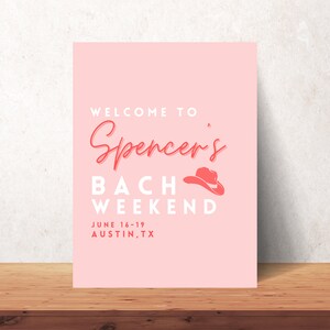 May include: A pink poster with the text "WELCOME TO Spencer's BACH WEEKEND" in white and coral lettering. A coral cowboy hat graphic is included. The dates "JUNE 16-19 AUSTIN, TX" are also displayed.