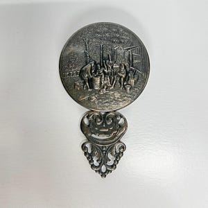 Vintage Silver Hand Mirror with Ornate Rural Scene on Back.
