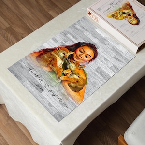 May include: A 500-piece jigsaw puzzle featuring a portrait of a person holding two small, brown puppies. The puzzle is partially assembled on a gray wooden-look surface. The text "dunkin & susan 2025" is written on the puzzle. A box with the puzzle image is next to the puzzle.