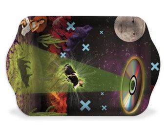 May include: A rectangular tray with a colorful, psychedelic design. The tray features a cow, a desert landscape, a moon with a face, and a glowing disc. The tray is perfect for serving snacks or drinks.