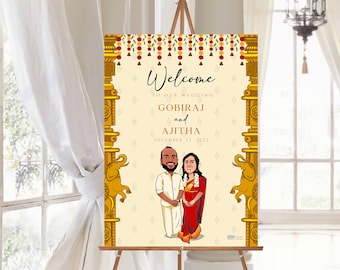 May include: A wedding welcome sign on an easel. The sign features a cartoon illustration of a couple, with the names GOBIRAJ and AJITHA, and the date November 25, 2023. The sign has a cream background with gold accents and floral decorations.