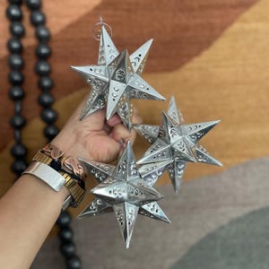 Adorno de aluminio con forma de estrella de doce puntas de México