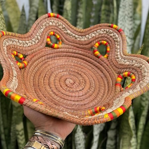 Medium woven and braided palm basket bowl with red, yellow, orange, green nylon thread wrap from Mexico