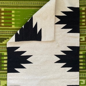 Handwoven natural wool rug from Teotitlan del Valle, Oaxaca, Mexico in natural grey wool color with geometric black designs