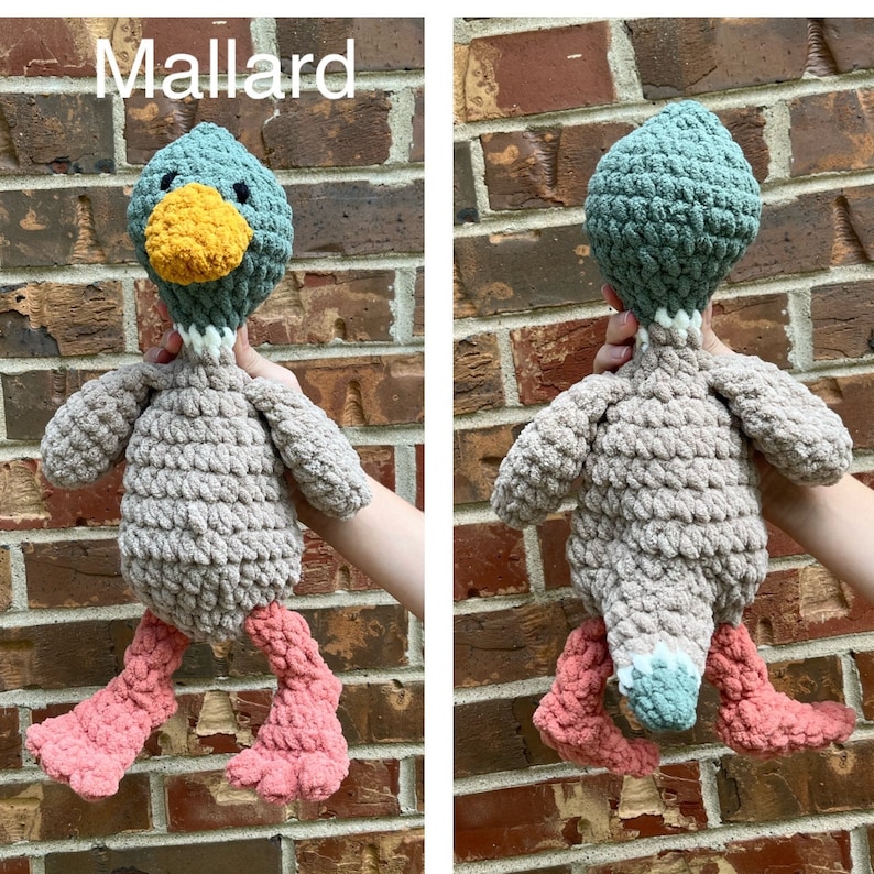 May include: A crocheted plush toy duck with a green head, brown body, pink feet, and a yellow beak. The duck is labeled "Mallard".