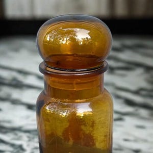 Vintage amber colored apothecary jar. Glass jar with lid.Mid Century Modern Kitchen or Bathroom Canister.Bubble top storage container.