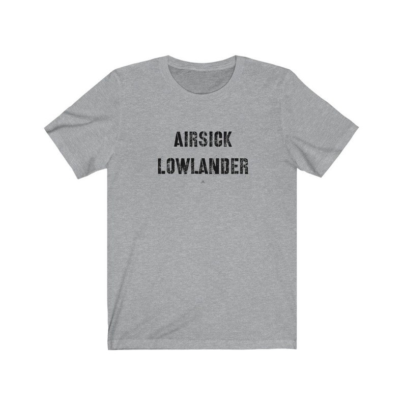May include: A gray t-shirt with the text "AIR SICK LOWLANDER" printed in black.