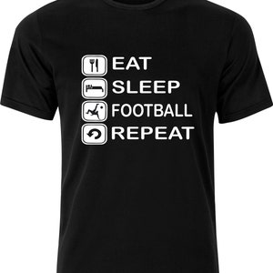 May include: Black t-shirt with a white graphic that says "Eat, Sleep, Football, Repeat" with icons for each activity.