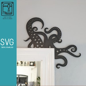May include: Black metal octopus corner bracket with a dotted pattern. The bracket is attached to a white door frame.