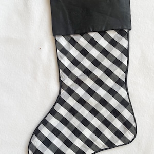 May include: Black and white checkered Christmas stocking with a black satin cuff.