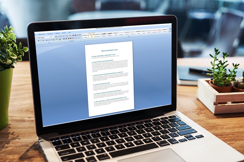 May include: A laptop computer with a white background and a document open on the screen. The document is titled "Self Maintenance Page 1" and contains a list of questions. The laptop is on a wooden table with a green plant and a small succulent plant in a wooden box.