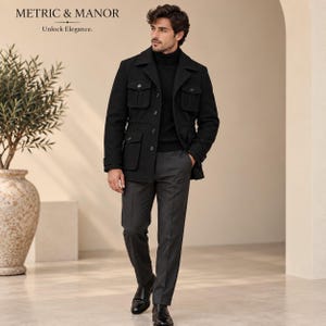 May include: A black field jacket with four front flap pockets and button closures, worn over a black turtleneck sweater and charcoal grey trousers. The jacket features a collared neckline and a button-up front. The text METRIC & MANOR Unlock Elegance is visible.