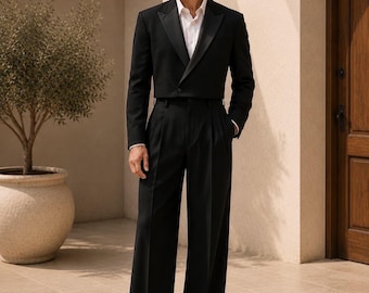 May include: A black cropped tuxedo jacket with satin lapels worn over a crisp white button-down shirt, paired with high-waisted black wide-leg trousers and black leather dress shoes. The ensemble features a single-button closure on the jacket.