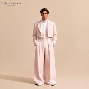 May include: A light pink ensemble featuring a cropped blazer with structured shoulders and long sleeves, paired with high-waisted, wide-leg trousers. A crisp white button-down shirt is worn underneath. The text METRIC & MANOR Unlock Elegance is visible.