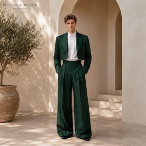 May include: A dark green suit consisting of a cropped blazer and high-waisted wide-leg trousers, paired with a crisp white button-down shirt. The ensemble features clean lines, a structured fit, and a solid deep forest green color throughout.