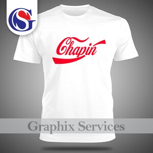 May include: A white t-shirt featuring the word "Chapin" in red, in a distinctive font, across the chest. The shirt has a crew neck and short sleeves. The image also includes a logo in the upper left corner and the text "Graphix Services" at the bottom.