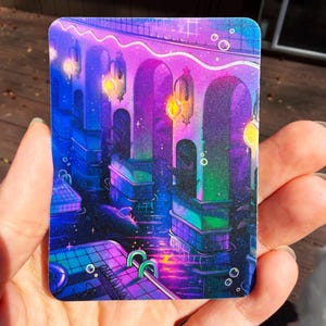 May include: A rectangular sticker featuring a vibrant digital illustration of an indoor swimming pool at night. The scene is illuminated by glowing yellow lanterns hanging from arched pillars, casting purple, blue, and green light reflections.