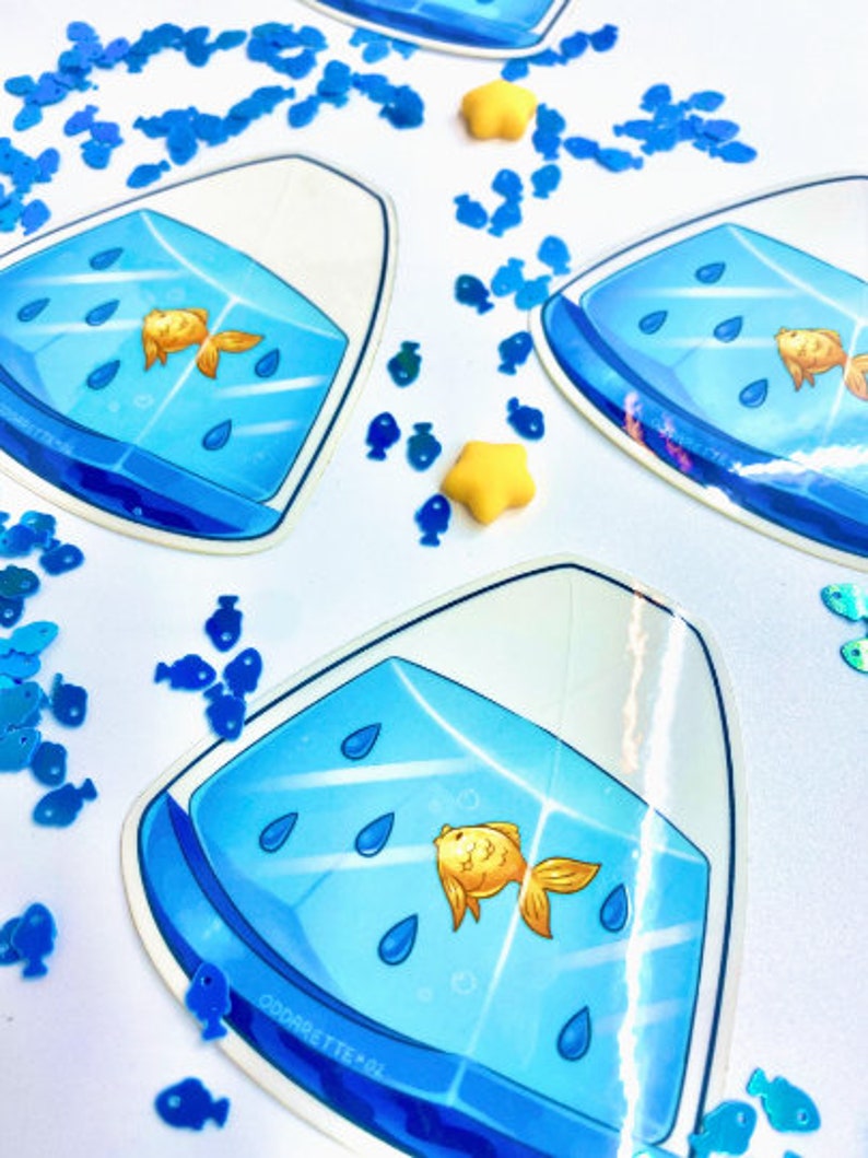May include: A blue and white sticker with a goldfish in a bowl. The bowl is filled with blue water and has raindrops falling into it. The sticker is surrounded by blue fish confetti.