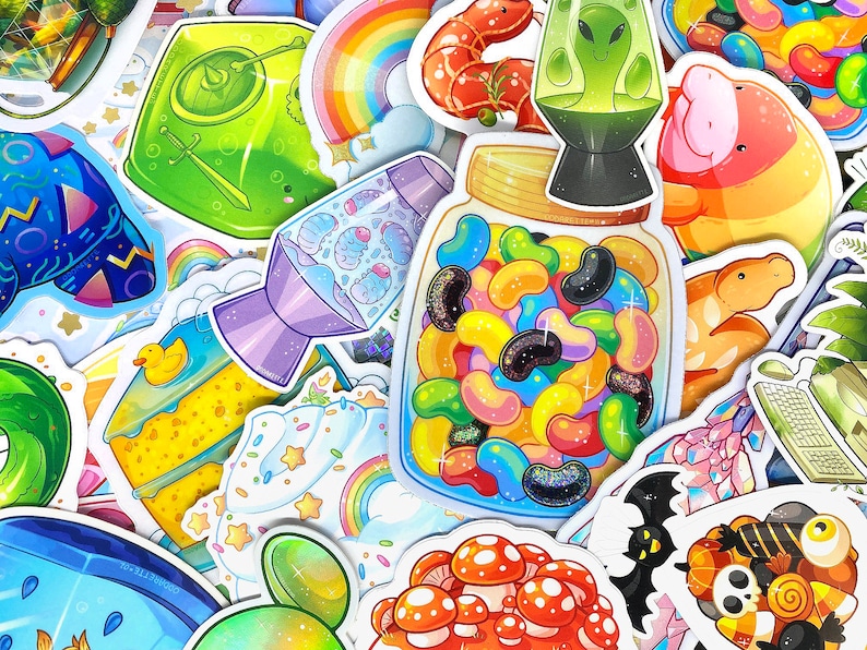 May include: A collection of colorful stickers featuring various designs, including a rainbow, a jar of jelly beans, a cake, a lava lamp, and a mushroom. The stickers are perfect for adding a touch of whimsy to laptops, water bottles, or journals.