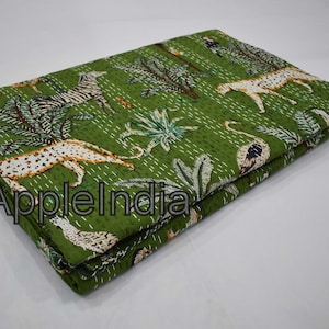 May include: A green kantha quilt with a white stitched pattern featuring various animals, including zebras, leopards, and birds. The quilt is folded in half and has the text "AppleIndia" printed on the fabric.