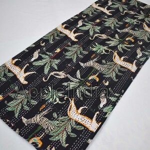 Puede incluir: Colcha kantha negra con un patr&oacute;n repetido de leopardos, cebras y palmeras. La colcha est&aacute; cosida a mano y tiene un dise&ntilde;o tradicional indio.