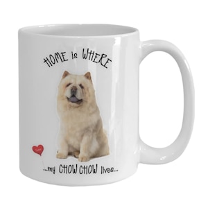 May include: White ceramic coffee mug with a picture of a cream colored Chow Chow dog. The mug has the text "HOME is WHERE...my CHOW CHOW lives..." with a red heart balloon.
