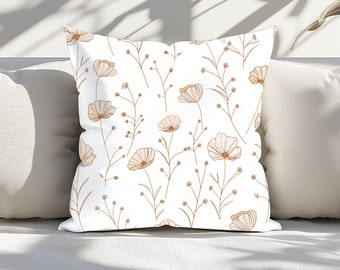 May include: White throw pillow with a brown floral pattern. The pillow features a repeating pattern of delicate flowers and stems.