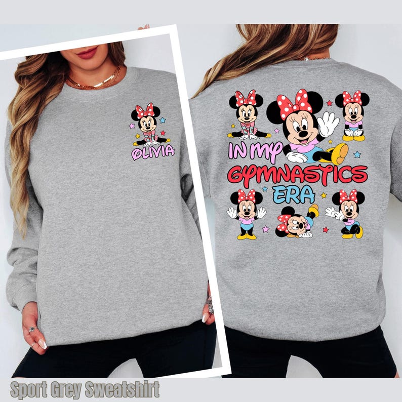 A gray sweatshirt with a design featuring Minnie Mouse and the text "In my gymnastics era" printed on the back.
