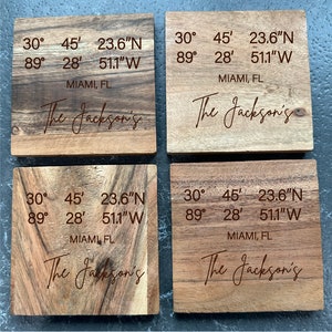 May include: Four wooden coasters with engraved coordinates, "30° 45' 23.6"N 89° 28' 51.1"W", and the text "The Jackson's" and "MIAMI, FL".
