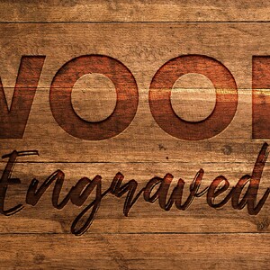 May include: A close-up of a wooden surface with the word "WOOD" and the word "Engraved" carved into it. The letters are a darker shade of brown than the background, which has a wood grain pattern.