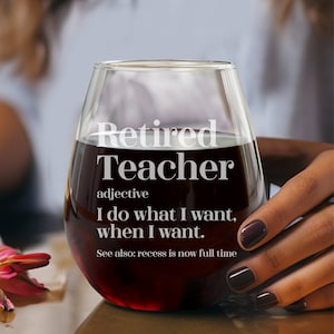 May include: A stemless wine glass filled with red liquid. The glass has the words "Retired Teacher" printed on it, along with a definition. The text reads "I do what I want, when I want." and "See also: recess is now full time."