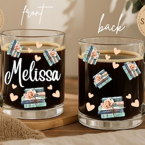 May include: Clear glass mug filled with dark coffee, decorated with book and heart illustrations. The name "Melissa" is written in white script on the front. The mug has a handle and is on a wooden surface.