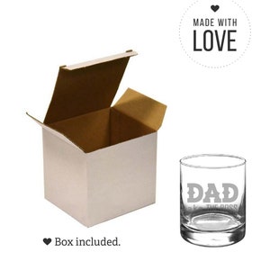 May include: A clear glass with the words "DAD aka THE BOSS" etched on the side. The glass is in a white box with a brown cardboard lid. The box is open and the lid is propped up behind the glass. A heart symbol and the words "MADE WITH LOVE" are in a circle above the glass.