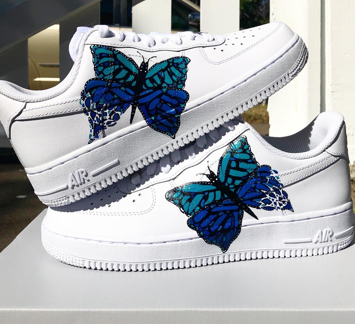 white shoes with blue butterflies