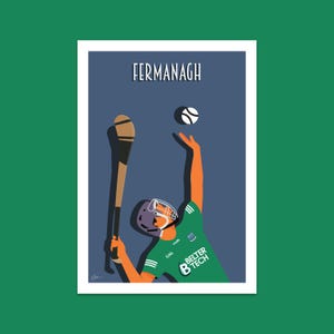 May include: A green and white illustration of a hurley player catching a ball. The player is wearing a helmet and a jersey with the text "Belter B Tech" on it. The background is a dark blue color with the word "Fermanagh" at the top.