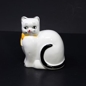Vintage black and white ceramic cat bank, yellow bow, Japan, small chip with blue color transfer on ear