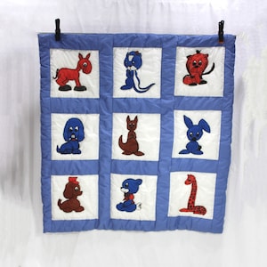 Vintage blue and white patchwork animal quilt; 9 squares with different animals painted in each; quilted animal outlines and borders