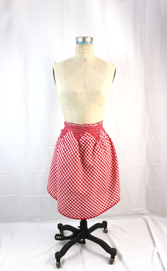 Red gingham vintage apron. Smocked with red embroidery floss. Rick rack edging.