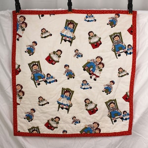 Vintage Raggedy Ann and Andy childrens quilt with red and yellow flowered back