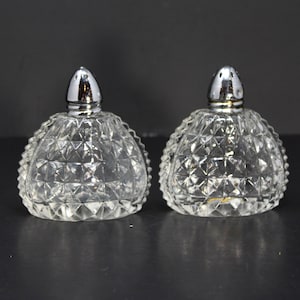 Vintage clear cut glass dome-shaped salt and pepper shakers w/ crisscross pattern; zigzag pattern on side edges; silver lids; Japan